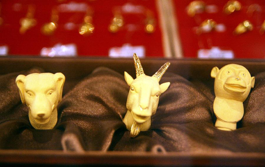 Photo taken on Nov. 13, 2011 shows gold copies of the dog, sheep and monkey head sculptures of Yuanmingyuan, the Old Summer Palace, at a shopping center in Nanjing, capital of east China's Jiangsu Province. 